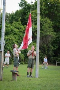 Troop 1 lowers the camp flags